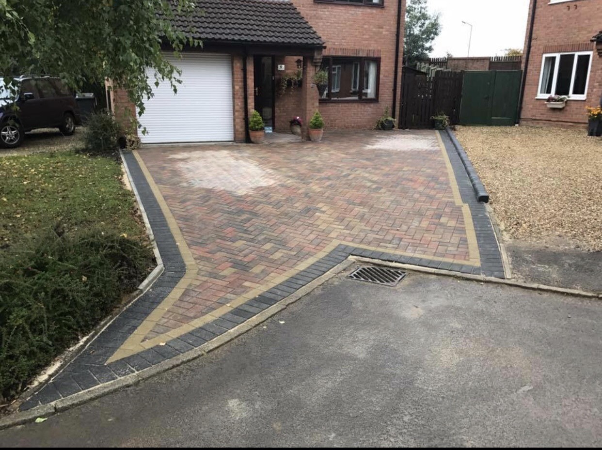 some work carried out last month for a bock paved driveway with a black border finished off to the road